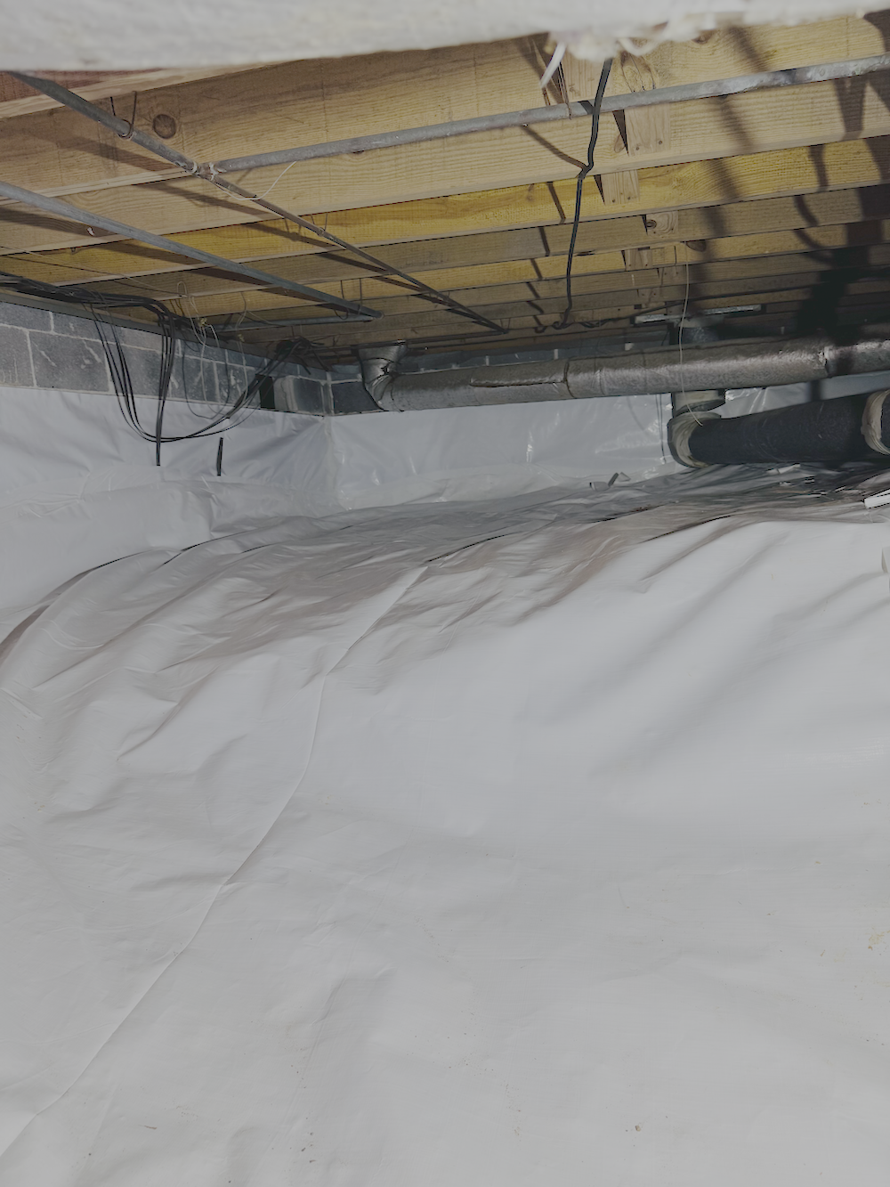 After: crawl space encapsulation in Birmingham, AL with sealed vapor barrier and clean joists